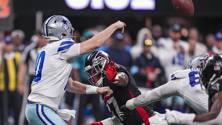 Dallas Cowboys quarterback Cooper Rush passes over Atlanta Falcons defensive end Grady Jarrett.
