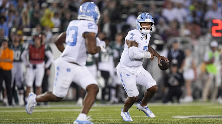 Sep 6, 2025; Charlotte, North Carolina, USA; North Carolina Tar Heels quarterback Gio Lopez (7) looks to throw to running back Charleston French (23) during the first quarter against the Charlotte 49ers at Jerry Richardson Stadium. Mandatory Credit: Jim Dedmon-Imagn Images
