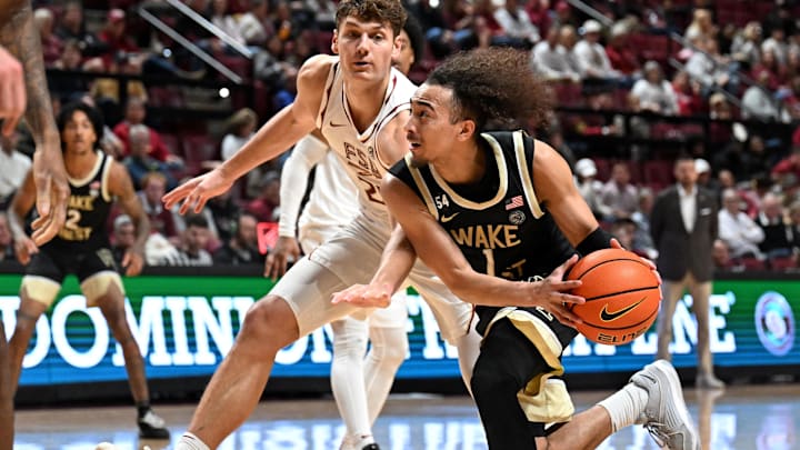 Jan 17, 2026; Tallahassee, Florida, USA; Wake Forest Demon Deacons guard Nate Calmese (1) drives the ball past Florida State Seminoles forward Alex Steen (25) during the second half at Donald L. Tucker Center. Mandatory Credit: Melina Myers-Imagn Images