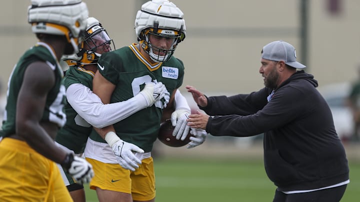 Jason Rebrovich runs the defensive linemen through drills at training camp.