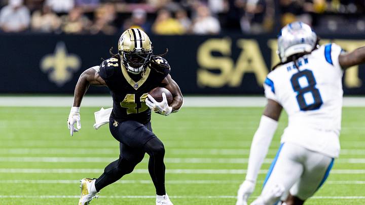 Sep 8, 2024; New Orleans, Louisiana, USA;  New Orleans Saints running back Alvin Kamara (41) runs against Carolina Panthers cornerback Jaycee Horn (8) during the first half at Caesars Superdome. Mandatory Credit: Stephen Lew-Imagn Images