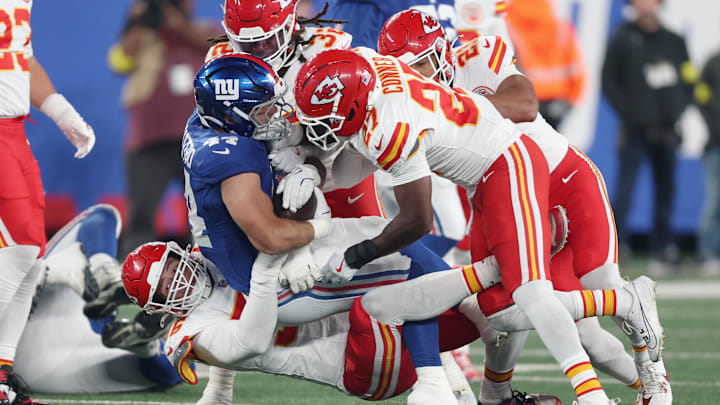 Sep 21, 2025; East Rutherford, New Jersey, USA; Kansas City Chiefs defensive end George Karlaftis (56) and defensive back Chamarri Conner (27) and linebacker Nick Bolton (32) tackle New York Giants running back Cam Skattebo (44) in the first quarter at MetLife Stadium. Mandatory Credit: Vincent Carchietta-Imagn Images