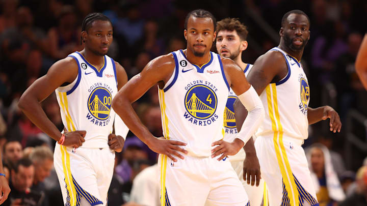 Oct 25, 2022; Phoenix, Arizona, USA; Golden State Warriors guard Moses Moody (4), forward Jonathan Kuminga (00) and forward Draymond Green (23) against the Phoenix Suns at Footprint Center. Mandatory Credit: Mark J. Rebilas-Imagn Images