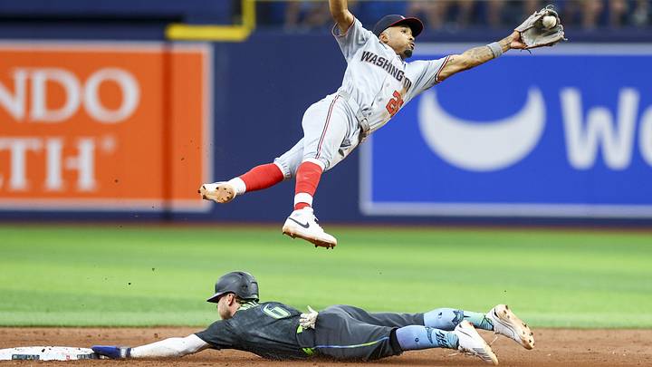 Jun 20, 2026; St. Petersburg, Florida, USA; Tampa Bay Rays shortstop Taylor Walls (6) steals second base under Washington Nationals second baseman Nasim Nunez (26) in the ninth inning at Tropicana Field. Mandatory Credit: Nathan Ray Seebeck-Imagn Images