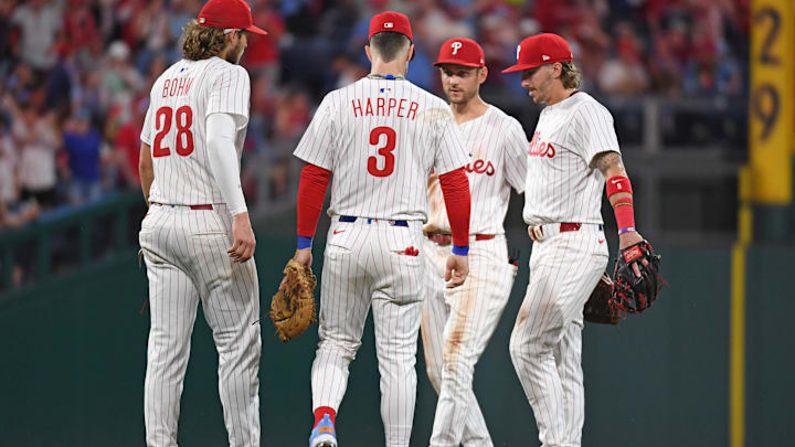 Jun 30, 2025; Philadelphia, Pennsylvania, USA; Philadelphia Phillies third base Alec Bohm (28), first base Bryce Harper (3), shortstop Trea Turner (7) and second base Bryson Stott (5) celebrate win against the San Diego Padres at Citizens Bank Park. 