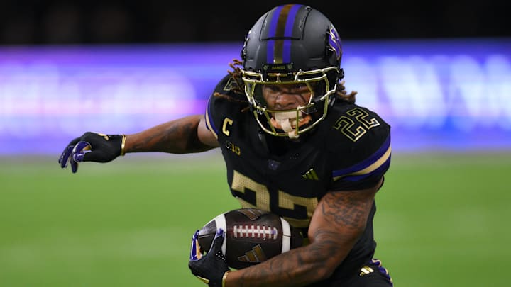 Nov 15, 2024; Seattle, Washington, USA; Washington Huskies running back Cameron Davis (22) carries the ball against the UCLA Bruins during the first half at Alaska Airlines Field at Husky Stadium.