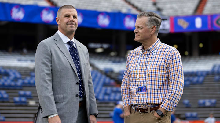 Oct 5, 2024; Gainesville, Florida, USA; Florida Gators head coach Billy Napier and Florida Gators athletic director Scott Stricklin talk before a game against the UCF Knights at Ben Hill Griffin Stadium. Mandatory Credit: Matt Pendleton-Imagn Images