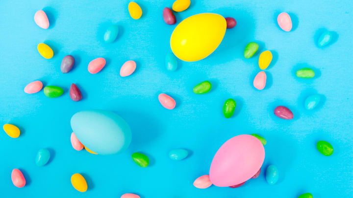 Easter eggs and candy on blue background