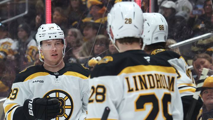 Apr 13, 2025; Pittsburgh, Pennsylvania, USA;  Boston Bruins center Morgan Geekie (39) celebrates with center Elias Lindholm (28) and right wing David Pastrnak (88)  after scoring a goal against the Pittsburgh Penguins during the second period at PPG Paints Arena. Mandatory Credit: Charles LeClaire-Imagn Images