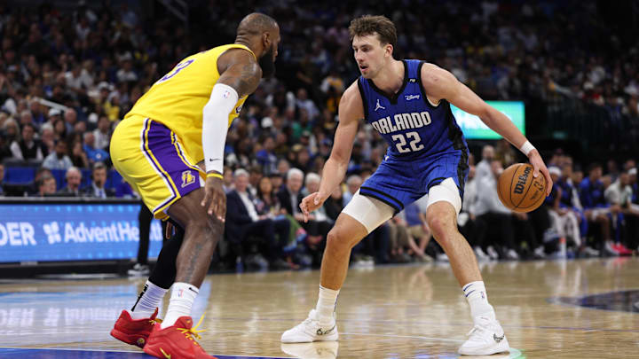 Orlando Magic forward Franz Wagner (22) controls the ball from Los Angeles Lakers forward LeBron James (23) in the fourth quarter at Kia Center.