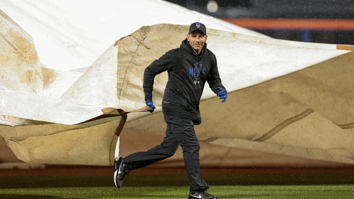 Apr 28, 2023; New York City, New York, USA; A member of the Citi Field grounds crew helps pull out