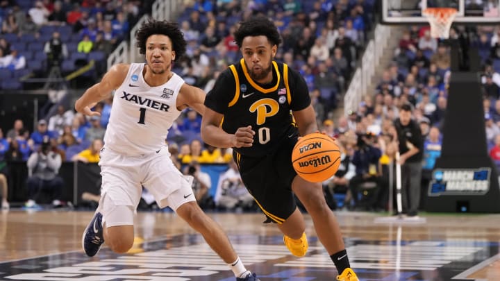 Mar 19, 2023; Greensboro, NC, USA; Pittsburgh Panthers guard Nelly Cummings (0) drives to the basket as Xavier Musketeers guard Desmond Claude (1) defends during the first half in the second round of the 2023 NCAA men   s basketball tournament at Greensboro Coliseum. Mandatory Credit: Bob Donnan-USA TODAY Sports