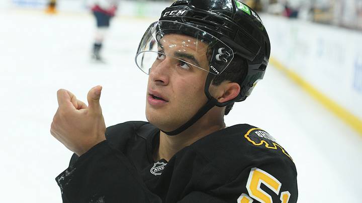 Sep 21, 2025; Boston, Massachusetts, USA; Boston Bruins center Matthew Poitras (51) shows the official blood from his mouth after getting hit in the mouth during the third period against the Washington Capitals at TD Garden. Mandatory Credit: Bob DeChiara-Imagn Images