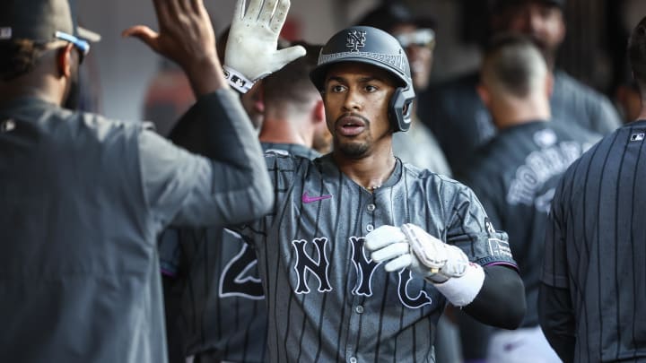 Jul 13, 2024; New York City, New York, USA; New York Mets shortstop Francisco Lindor (12) is greeted in the dugout after hitting a three run home run in the eighth inning against the Colorado Rockies at Citi Field. Mandatory Credit: Wendell Cruz-USA TODAY Sports