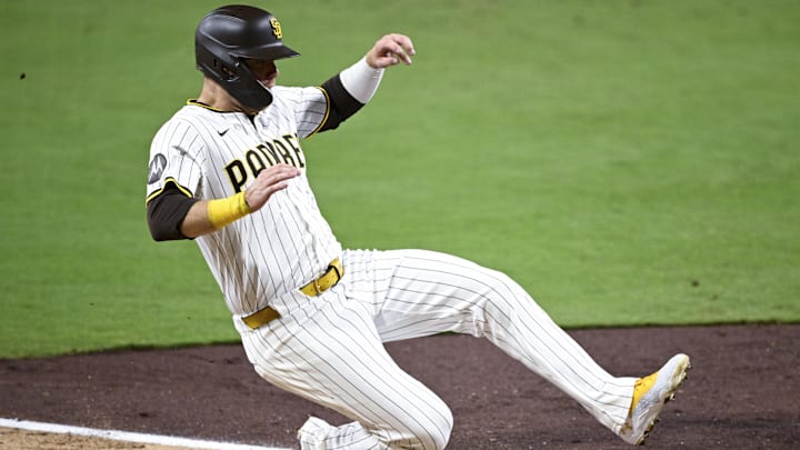 Jul 10, 2025; San Diego, California, USA; San Diego Padres left fielder Gavin Sheets (30) slides as he scores during the fifth inning against the Arizona Diamondbacks at Petco Park. Mandatory Credit: Denis Poroy-Imagn Images a