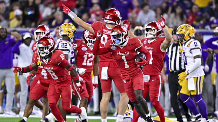 Dec 27, 2025; Houston, TX, USA; Houston Cougars defensive back Latrell McCutchin Sr. (1) recovers the onside kick during the second half against the Louisiana State Tigers at NRG Stadium. Mandatory Credit: Maria Lysaker-Imagn Images 