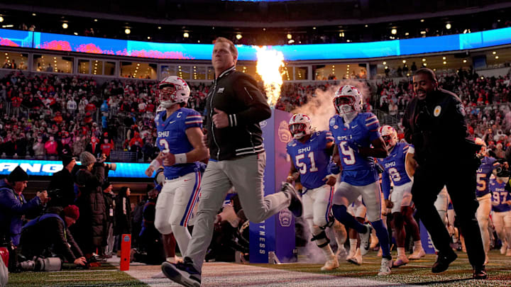 Southern Methodist Mustangs head coach Rhett Lashlee leads his team to the field before the 2024 ACC Championship Game against the Clemson Tigers at Bank of America Stadium. 