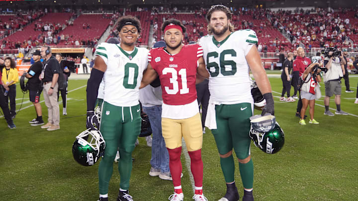 Sep 9, 2024; Santa Clara, California, USA; San Francisco 49ers running back Isaac Guerendo (31) poses for a photo with New York Jets running back Braelon Allen (0) and center Joe Tippmann (66) after the game at Levi's Stadium. Mandatory Credit: Darren Yamashita-Imagn Images