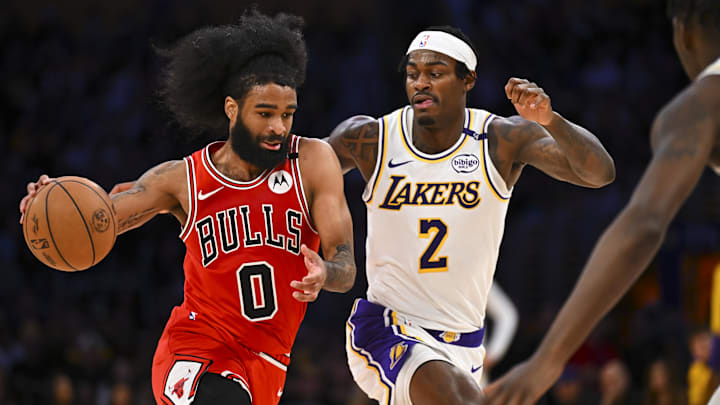Mar 22, 2025; Los Angeles, California, USA; Chicago Bulls guard Coby White (0) drives the ball against Los Angeles Lakers forward Jarred Vanderbilt (2) during the second half at Crypto.com Arena. Mandatory Credit: Jonathan Hui-Imagn Images