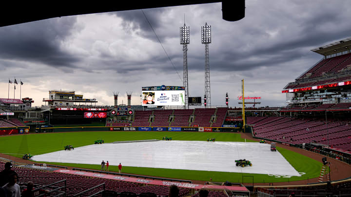 Fans make their ways into the stadium as a rain delay is announced before the first inning of the MLB National League game between the Cincinnati Reds and the Washington Nationals at Great American Ball Park in downtown Cincinnati on Friday, May 2, 2025.