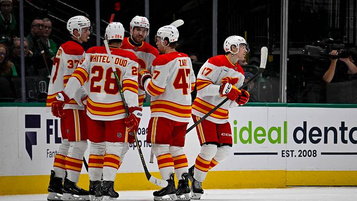 Apr 7, 2026; Dallas, Texas, USA; Calgary Flames defenseman Yan Kuznetsov (37) and defenseman Zach Whitecloud (28) and center Connor Zary (47) and center Yegor Sharangovich (17) celebrates a goal scored by Sharangovich against the Dallas Stars during the second period at the American Airlines Center. Mandatory Credit: Jerome Miron-Imagn Images