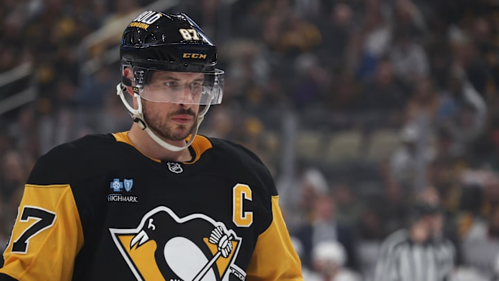Mar 30, 2025; Pittsburgh, Pennsylvania, USA;  Pittsburgh Penguins center Sidney Crosby (87) looks on at the face-off circle against the Ottawa Senators during the first period at PPG Paints Arena. Mandatory Credit: Charles LeClaire-Imagn Images