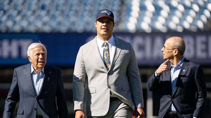 May 7, 2026; Foxborough, MA, USA; New England Patriots owner Robert Kraft (l) and Patriots president Jonathan Kraft (r) walk with first round draft pick Caleb Lomu (c) to the podium for a press conference on the game field at Gillette Stadium. Mandatory Credit: Natalie Reid-Imagn Images