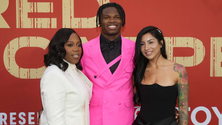 Jaguars wide receiver Travis Hunter with his mother Ferrante Harris and his fiancee Leanna Lenee on the red carpet before the 2025 NFL Draft at Lambeau Field.
