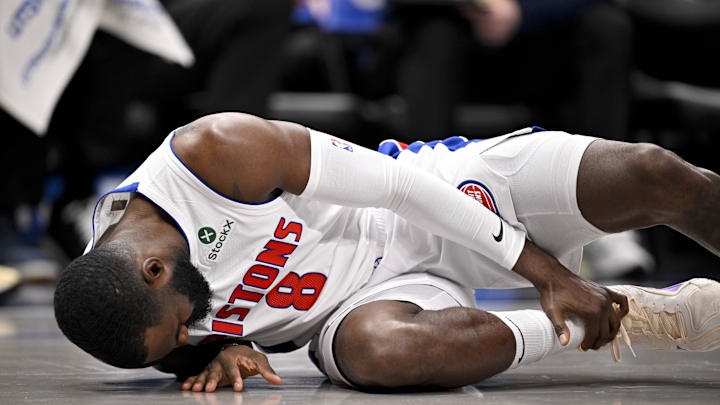 Mar 21, 2025; Dallas, Texas, USA; Detroit Pistons forward Tim Hardaway Jr. (8) grabs his leg after he falls to the floor during the first half against the Dallas Maverick at the American Airlines Center. Mandatory Credit: Jerome Miron-Imagn Images