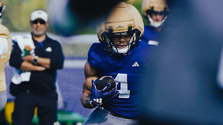 Jordan Washington looks for room to run at spring practice. 