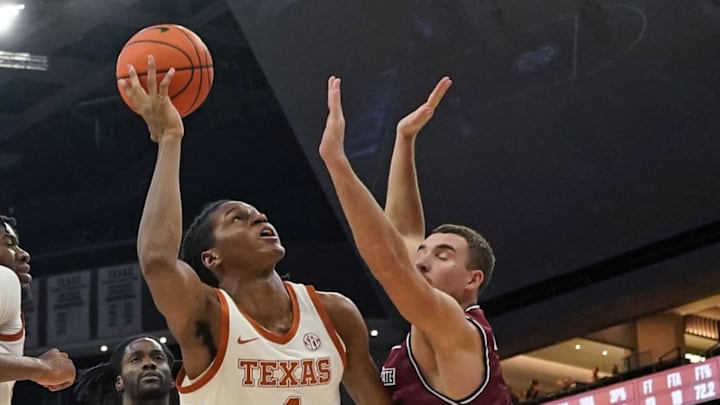 Texas Longhorns forward Jamie Vinson shoots over forward Peter Filipovity
