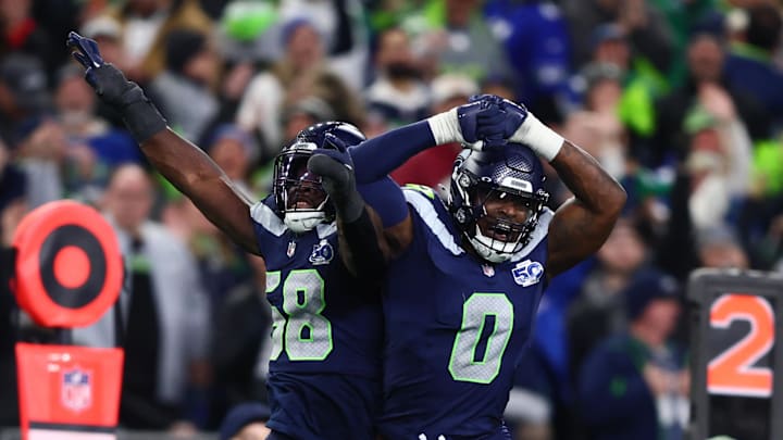 Seattle Seahawks linebacker Derick Hall (58) and defensive end DeMarcus Lawrence.