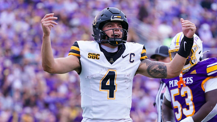 Sep 14, 2024; Greenville, North Carolina, USA; Appalachian State Mountaineers quarterback Joey Aguilar (4) reacts after the touchdown against the East Carolina Pirates during the first half at Dowdy-Ficklen Stadium. Mandatory Credit: James Guillory-Imagn Images Sep 14, 2024; Greenville, North Carolina, USA; Appalachian State Mountaineers quarterback Joey Aguilar (4) reacts after the touchdown against the East Carolina Pirates during the first half at Dowdy-Ficklen Stadium. Mandatory Credit: James Guillory-Imagn Images