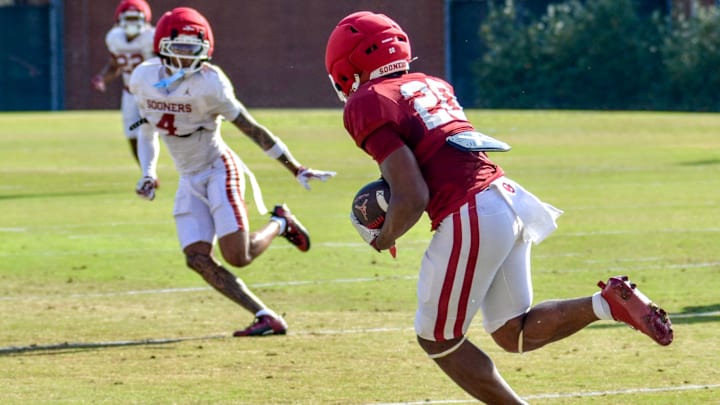 Oklahoma running back Jonathan Hatton Jr. rushes during practice. Oklahoma running back Jonathan Hatton Jr. rushes during practice.