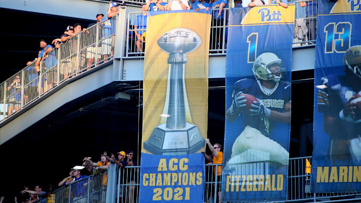 Former Pittsburgh Panthers including first round draft pick Kenny Pickett unveil the Panthers 2021 ACC Championship banner during the first half of the Backyard Brawl against the West Virginia Mountaineers at Acrisure Stadium in Pittsburgh, PA on September 1, 2022.

Pitt Vs West Virginia Backyard Brawl