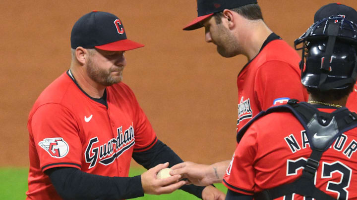 Sep 12, 2024; Cleveland, Ohio, USA; Cleveland Guardians manager Stephen Vogt (12) takes the ball from starting pitcher Gavin Williams (32) during a pitching change in the sixth inning against the Tampa Bay Rays at Progressive Field. Mandatory Credit: David Richard-Imagn Images