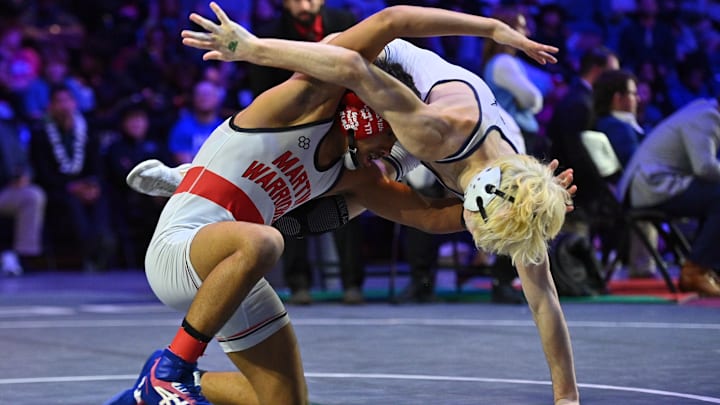 Arlington Martin's Isaak Arevalo, left, competes against The Woodlands College Park's Luca Rios in the Class 6A 126-pound championship on Saturday in Cypress.