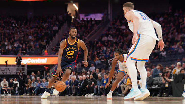 Jan 29, 2025; San Francisco, California, USA; Golden State Warriors forward Andrew Wiggins (22) drives to the hoop next to Oklahoma City Thunder center Isaiah Hartenstein (55) in the third quarter at the Chase Center. Mandatory Credit: Cary Edmondson-Imagn Images