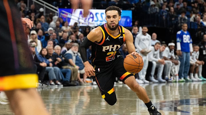 Dec 8, 2024; Orlando, Florida, USA; Phoenix Suns guard Tyus Jones (21) dribbles the ball against the Orlando Magic  in the third quarter at Kia Center. Mandatory Credit: Jeremy Reper-Imagn Images