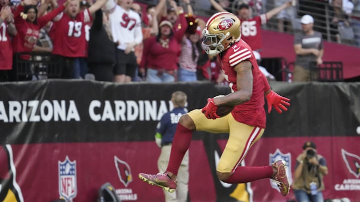 San Francisco 49ers cornerback Charvarius Ward (7) returns an interception for a touchdown against the Arizona Cardinals during the first quarter at State Farm Stadium in Glendale on Dec. 17, 2023.