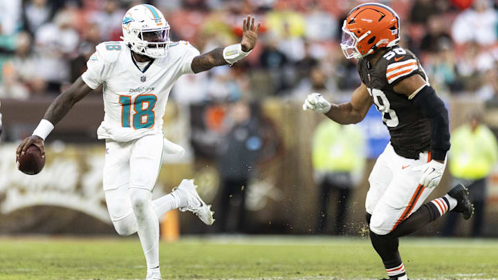 Dec 29, 2024; Cleveland, Ohio, USA; Miami Dolphins quarterback Tyler Huntley (18) is defended by Cleveland Browns linebacker Jordan Hicks (58) during the second quarter at Huntington Bank Field. Mandatory Credit: Scott Galvin-Imagn Images