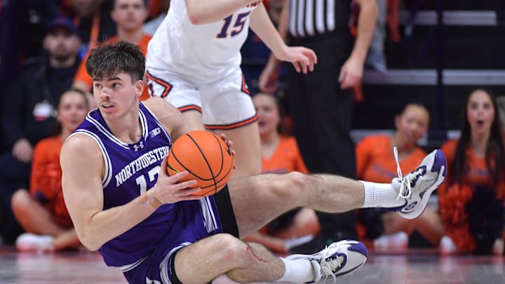 Jan 26, 2025; Champaign, Illinois, USA;  Northwestern Wildcats guard Brooks Barnhizer (13) grabs the ball off the court during the first half against the Illinois Fighting Illini at State Farm Center. Mandatory Credit: Ron Johnson-Imagn Images