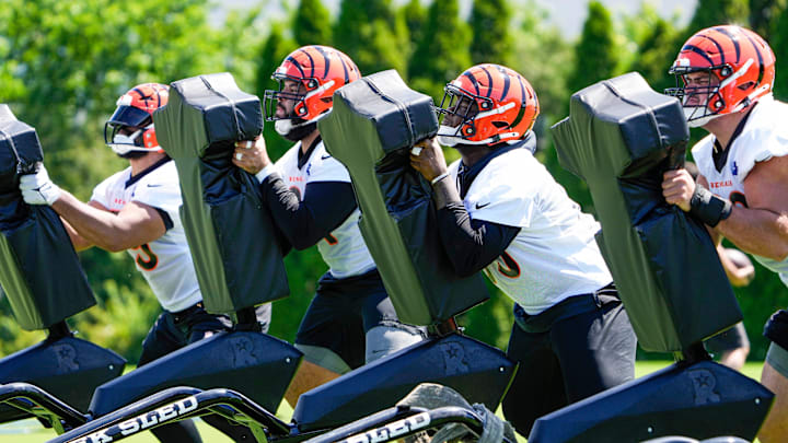 Members of the Bengals offensive line use a tackle sled during OTAs on Tuesday, May 28, 2024, at the Kettering Health Practice Fields outside of Paycor Stadium.
