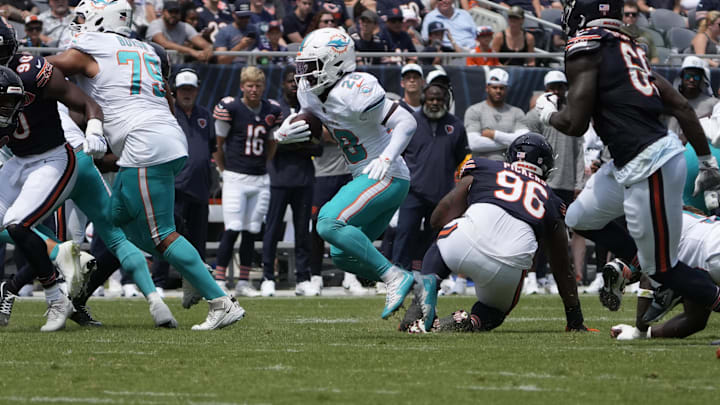 Miami Dolphins running back De'Von Achane (28) runs the ball against the Chicago Bears during the first half at Soldier Field on Sunday. Miami Dolphins running back De'Von Achane (28) runs the ball against the Chicago Bears during the first half at Soldier Field on Sunday.