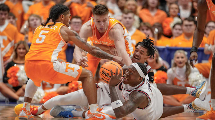 Auburn forward Ja'Heim Hudson (8) passes the ball past Tennessee guard Zakai Zeigler (5) during the first half of a Southeastern Conference tournament semifinal game at Bridgestone Arena in Nashville, Tenn., Saturday, March 15, 2025.