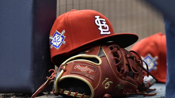Apr 15, 2019; Milwaukee, WI, USA; A cap rests on the dug out wall with the number 42 on the hat in honor of Major League Baseball   s Jackie Robinson Day. Mandatory Credit: Michael McLoone-Imagn Images