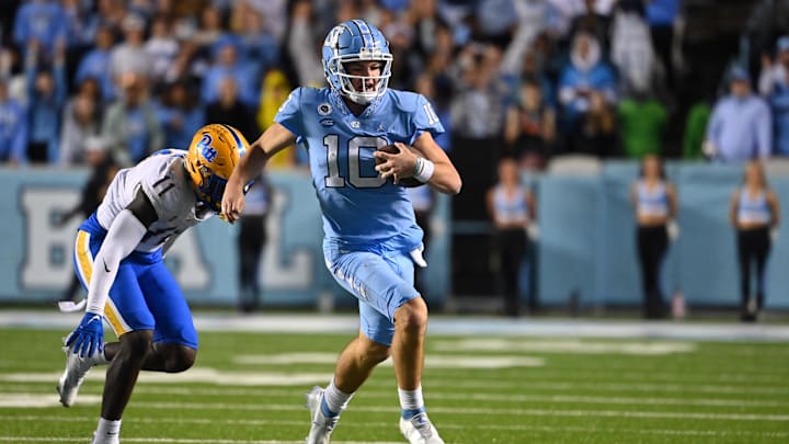 Oct 29, 2022; Chapel Hill, North Carolina, USA; *North Carolina Tar Heels quarterback Drake Maye (10) with the ball as Pittsburgh Panthers linebacker Bangally Kamara (11) defends in the third quarter at Kenan Memorial Stadium. Mandatory Credit: Bob Donnan-Imagn Images