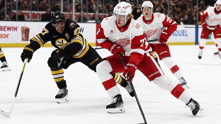 Nov 29, 2025; Boston, Massachusetts, USA; Detroit Red Wings defenseman Simon Edvinsson (77) tries to go around Boston Bruins defenseman Hampus Lindholm (27) during the second period at TD Garden. Mandatory Credit: Winslow Townson-Imagn Images Nov 29, 2025; Boston, Massachusetts, USA; Detroit Red Wings defenseman Simon Edvinsson (77) tries to go around Boston Bruins defenseman Hampus Lindholm (27) during the second period at TD Garden. Mandatory Credit: Winslow Townson-Imagn Images
