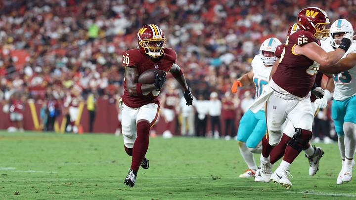 Washington Commanders running back Robert Henry Jr. (30) carries the ball to score a touchdown against the Miami Dolphins. Washington Commanders running back Robert Henry Jr. (30) carries the ball to score a touchdown against the Miami Dolphins.