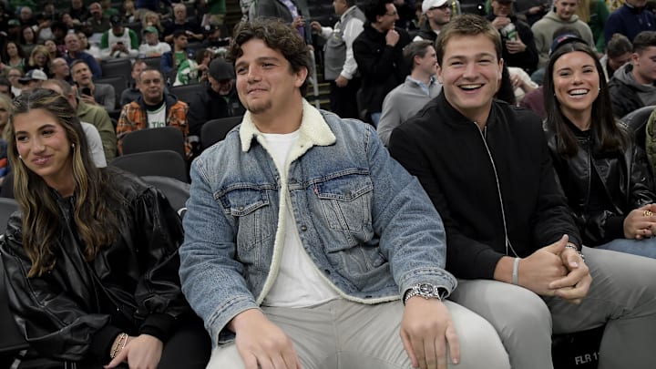 Nov 3, 2025; Boston, Massachusetts, USA; New England Patriots players Will Campbell and Drake Maye during the first half between the Boston Celtics and Utah Jazz at TD Garden. Mandatory Credit: Bob DeChiara-Imagn Images